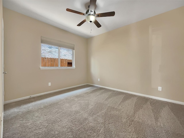 carpeted empty room featuring ceiling fan