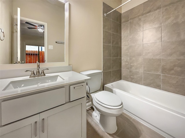 full bathroom featuring tiled shower / bath, tile patterned floors, vanity, and toilet