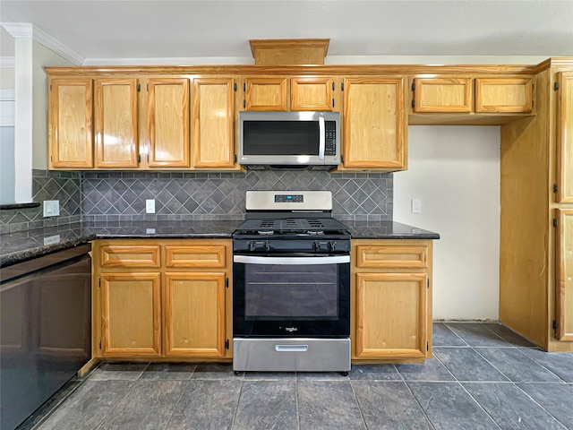 kitchen featuring dark stone countertops, decorative backsplash, stainless steel appliances, and crown molding