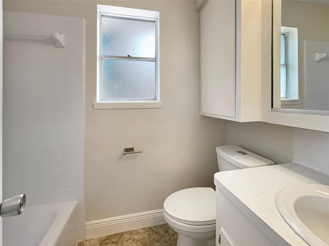 full bathroom featuring tiled shower / bath combo, vanity, and toilet