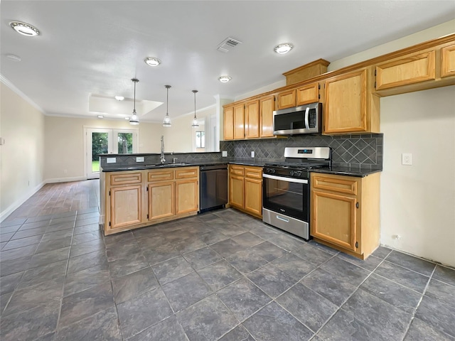 kitchen featuring appliances with stainless steel finishes, decorative light fixtures, sink, backsplash, and kitchen peninsula