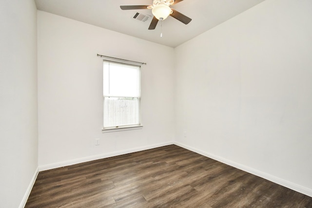 spare room featuring ceiling fan and dark wood-type flooring