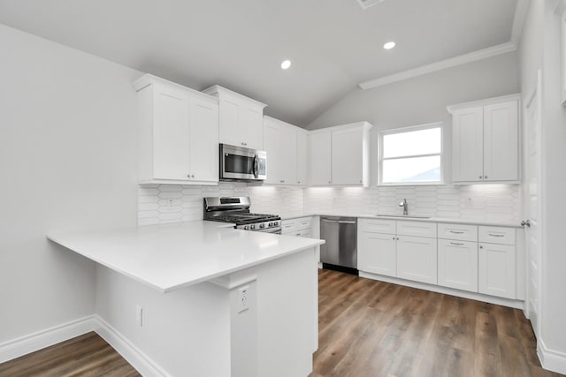 kitchen featuring decorative backsplash, white cabinets, and stainless steel appliances