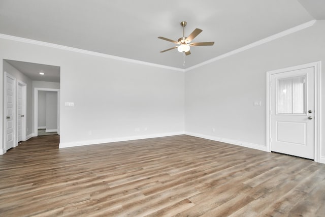 unfurnished living room featuring ceiling fan, hardwood / wood-style floors, and ornamental molding