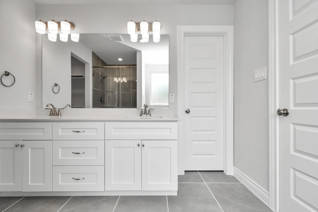 bathroom featuring tile patterned flooring, vanity, and a shower with shower door