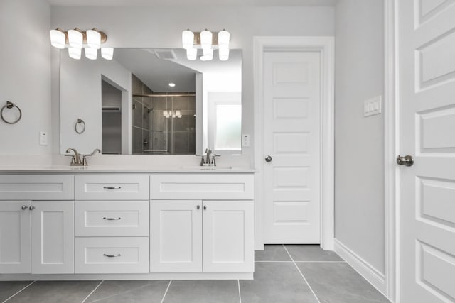 bathroom featuring a shower with door, vanity, and tile patterned flooring