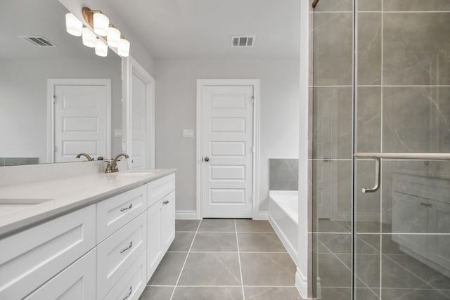 bathroom with tile patterned flooring, vanity, and separate shower and tub