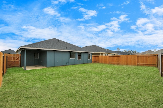 back of house with a yard