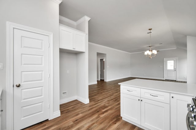 kitchen with white cabinets, dark wood-type flooring, vaulted ceiling, and a notable chandelier