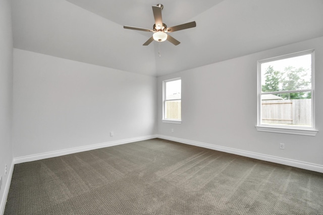 empty room with carpet floors, vaulted ceiling, and ceiling fan