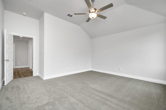 carpeted empty room featuring vaulted ceiling and ceiling fan