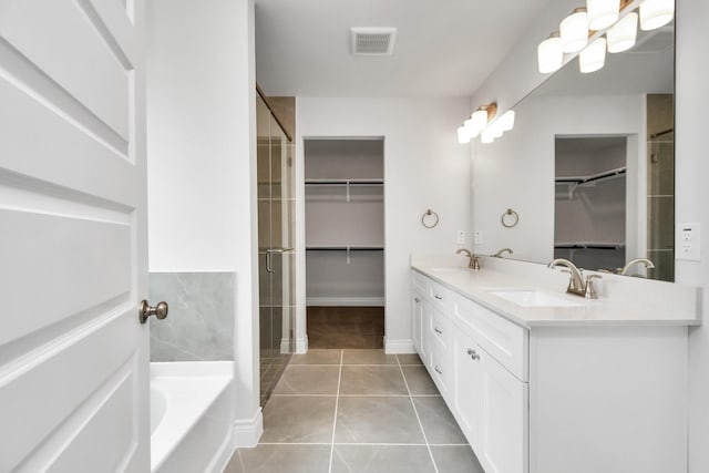 bathroom featuring tile patterned floors, a bathtub, and vanity