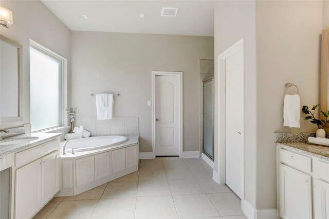 bathroom featuring vanity, tile patterned floors, and walk in shower