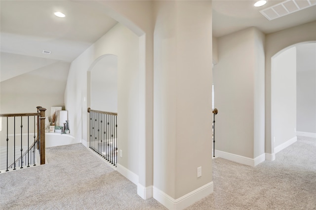 hallway featuring light colored carpet