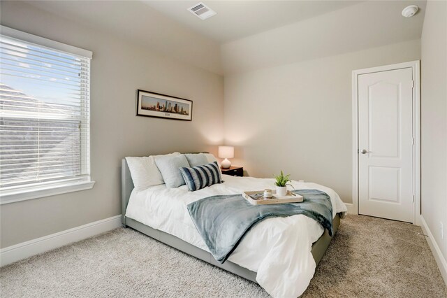 carpeted bedroom featuring lofted ceiling