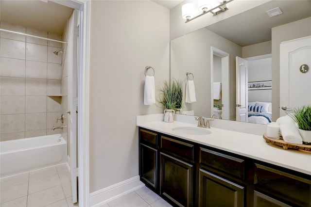 bathroom with tile patterned flooring, vanity, and tiled shower / bath combo