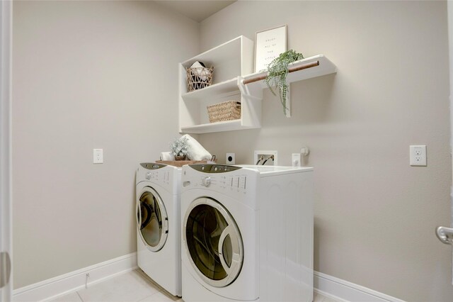 laundry area featuring light tile patterned floors and separate washer and dryer