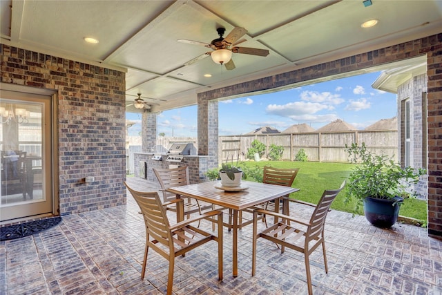 view of patio / terrace featuring ceiling fan and an outdoor kitchen