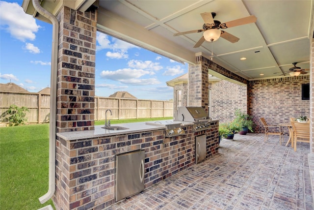 view of patio / terrace with a grill, area for grilling, and a wet bar