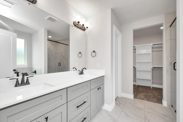 bathroom featuring vanity and a shower with door