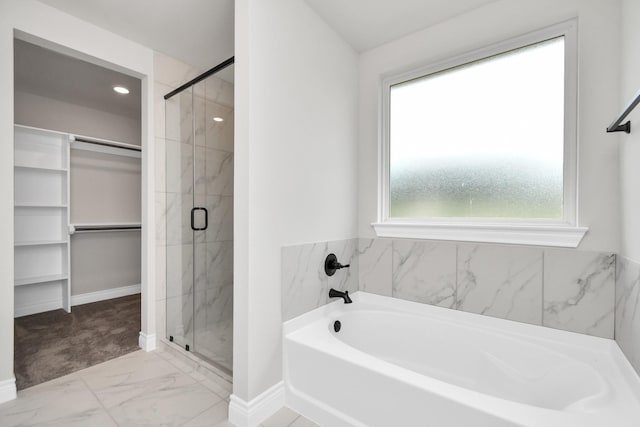 bathroom featuring separate shower and tub