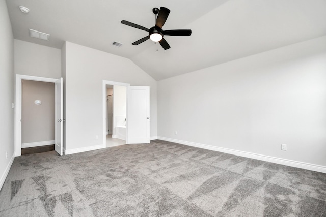 unfurnished bedroom featuring carpet, ceiling fan, ensuite bathroom, and vaulted ceiling