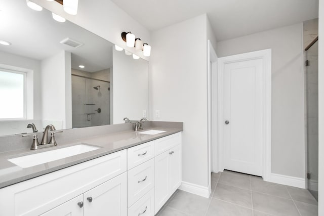 bathroom featuring vanity, tile patterned floors, and a shower with shower door