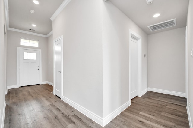 entrance foyer featuring wood-type flooring and ornamental molding