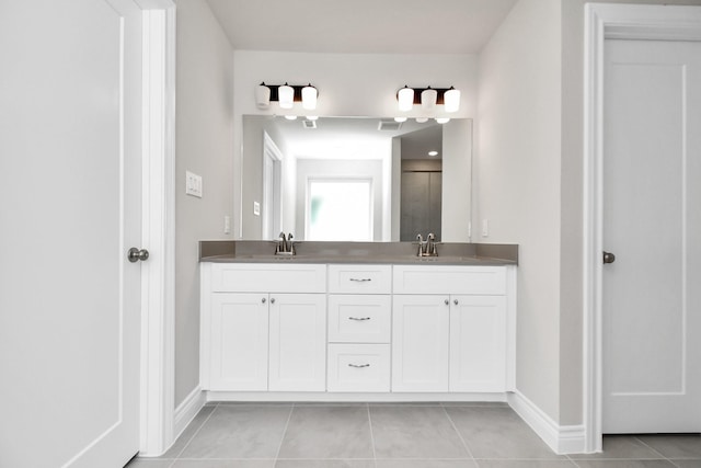 bathroom featuring tile patterned floors, a shower with door, and vanity