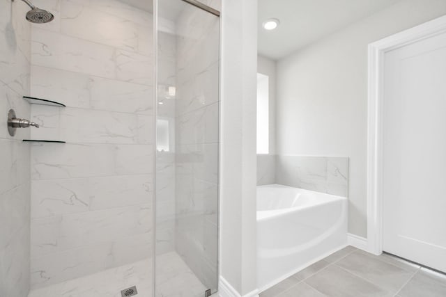 bathroom featuring tile patterned flooring and plus walk in shower