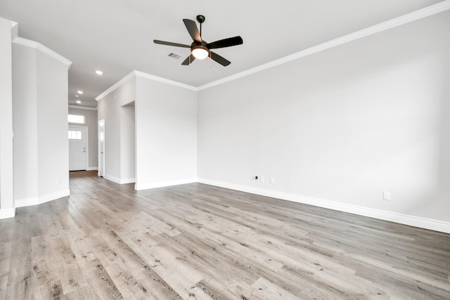 empty room featuring ceiling fan, light wood-type flooring, and crown molding