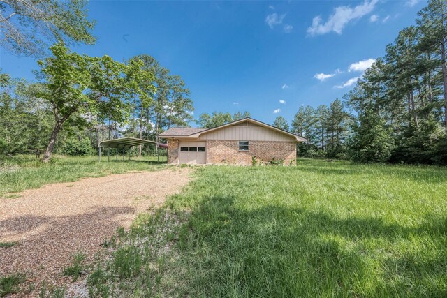 view of yard with a carport and a garage