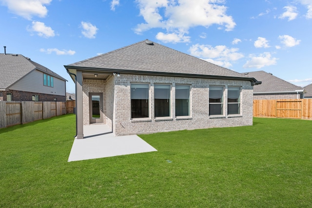 back of house with a yard and a patio area