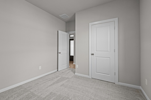 unfurnished bedroom featuring light colored carpet