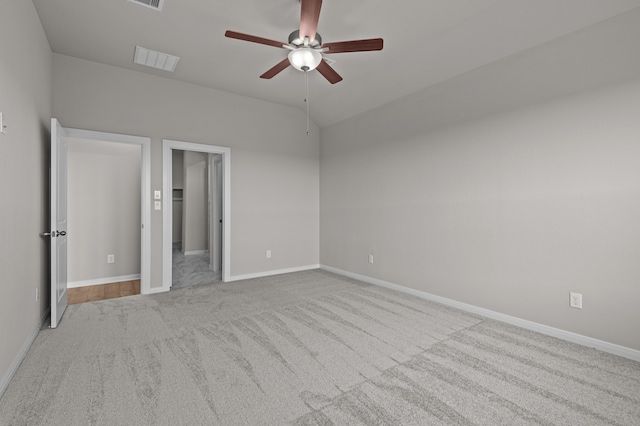 unfurnished bedroom with light carpet, ceiling fan, and lofted ceiling