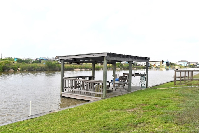 dock area with a yard and a water view