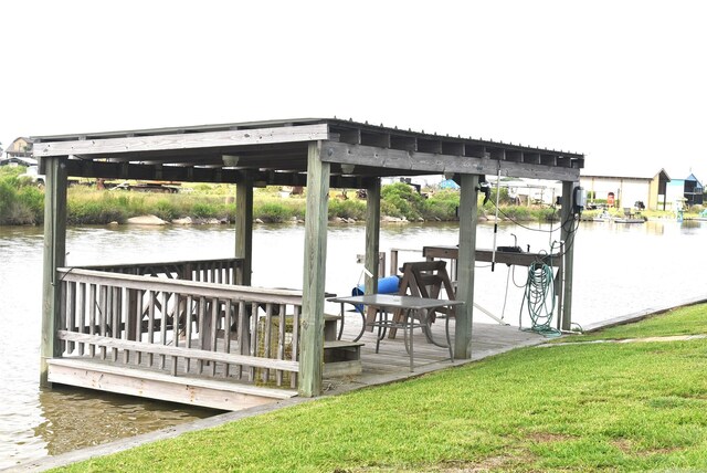 view of dock featuring a water view and a lawn