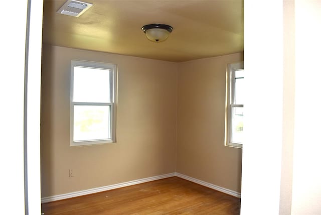 spare room featuring wood-type flooring