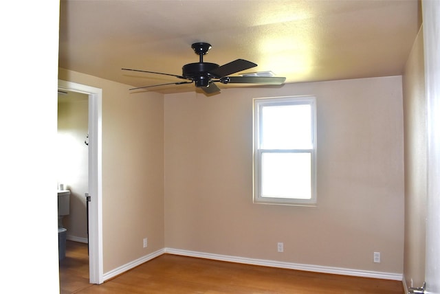 empty room with ceiling fan and light wood-type flooring