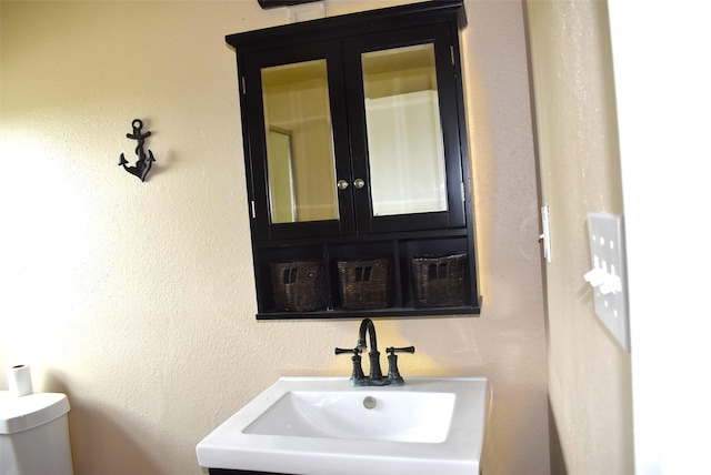 bathroom featuring sink and toilet