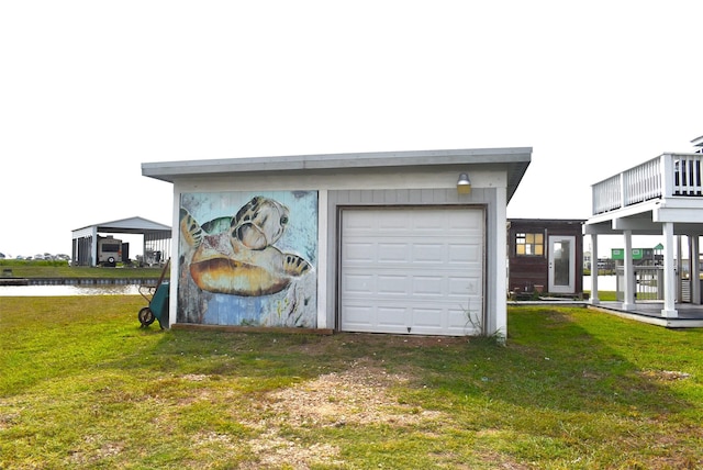 garage featuring a water view and a yard