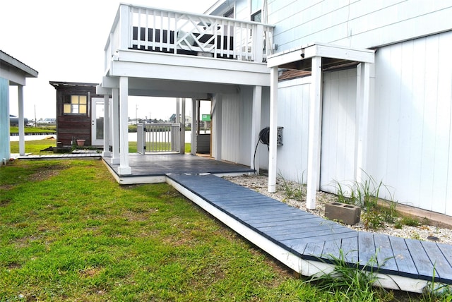 rear view of property featuring a yard and a deck