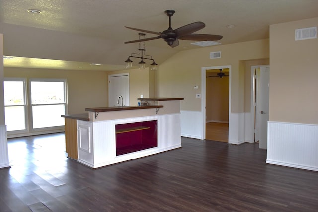 kitchen featuring lofted ceiling, sink, a center island with sink, dark hardwood / wood-style floors, and ceiling fan