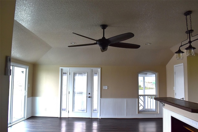 entryway featuring lofted ceiling, dark wood-type flooring, and a textured ceiling