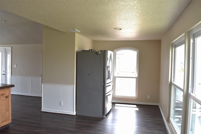 empty room featuring dark hardwood / wood-style floors and a textured ceiling