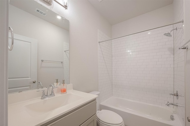 full bathroom with vanity, toilet, and tiled shower / bath