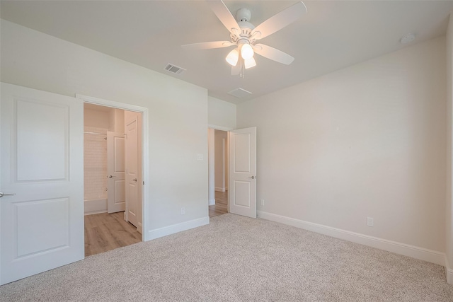 unfurnished bedroom featuring ceiling fan and light carpet