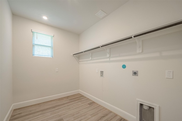 laundry area with hookup for an electric dryer, washer hookup, and light hardwood / wood-style flooring