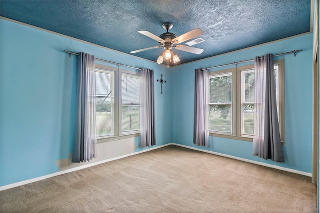 unfurnished room with ceiling fan, a textured ceiling, and carpet flooring