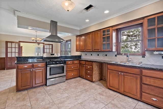 kitchen with sink, island range hood, a chandelier, stainless steel gas range oven, and crown molding